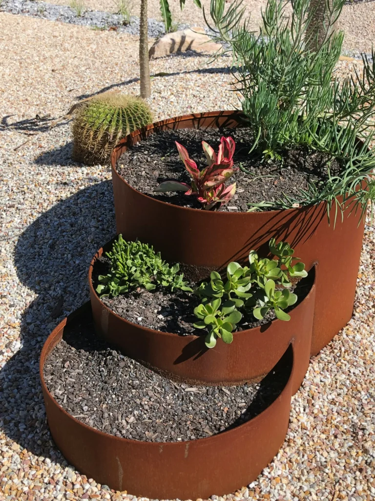 Corten steel edging with rust patina around a flower bed